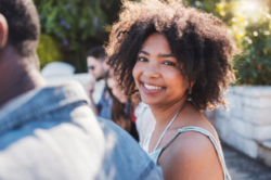 Happy, smile and portrait of a black woman at a party to relax with friends